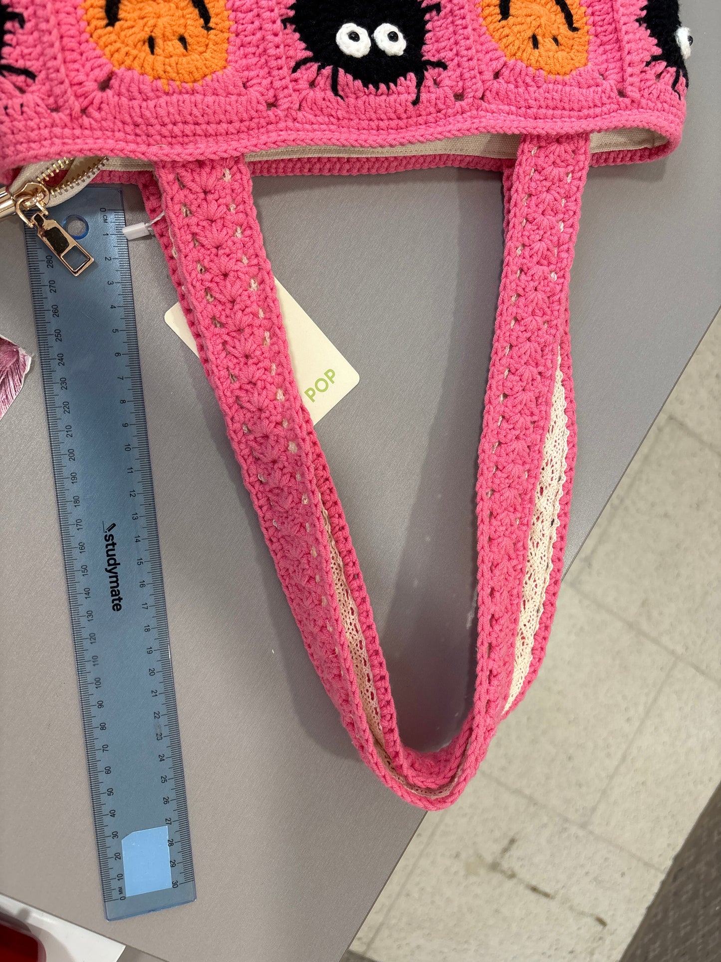 handmade crochet bag with a stylish smile face