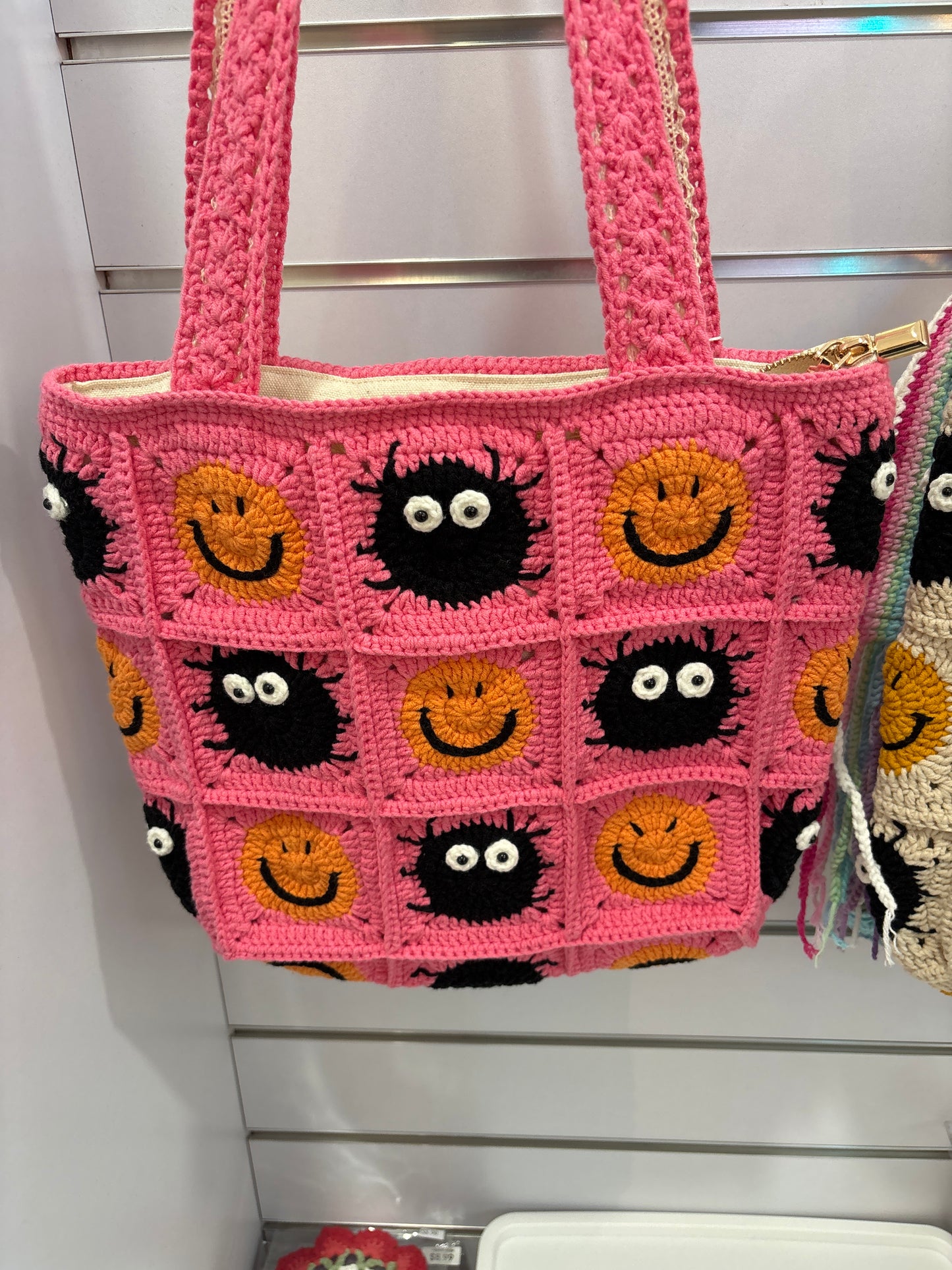handmade crochet bag with a stylish smile face