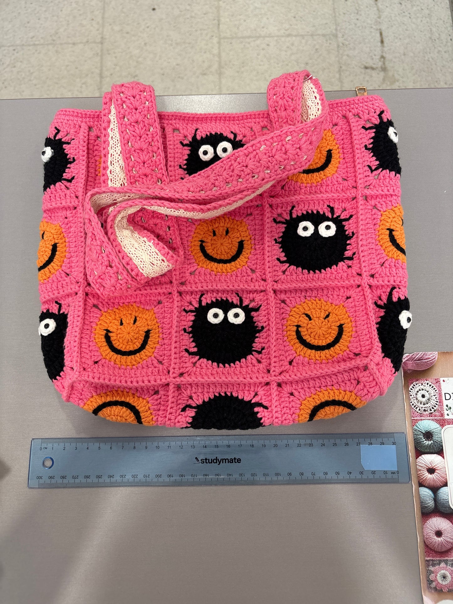 handmade crochet bag with a stylish smile face