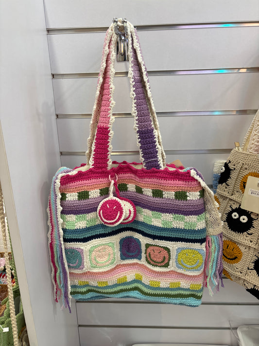 handmade crochet bag features a charming smile face pattern