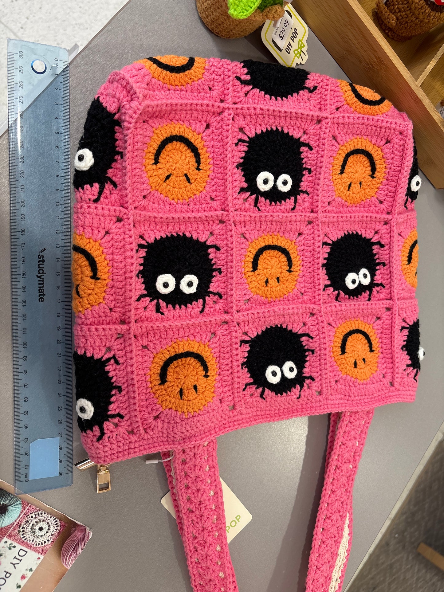 handmade crochet bag with a stylish smile face