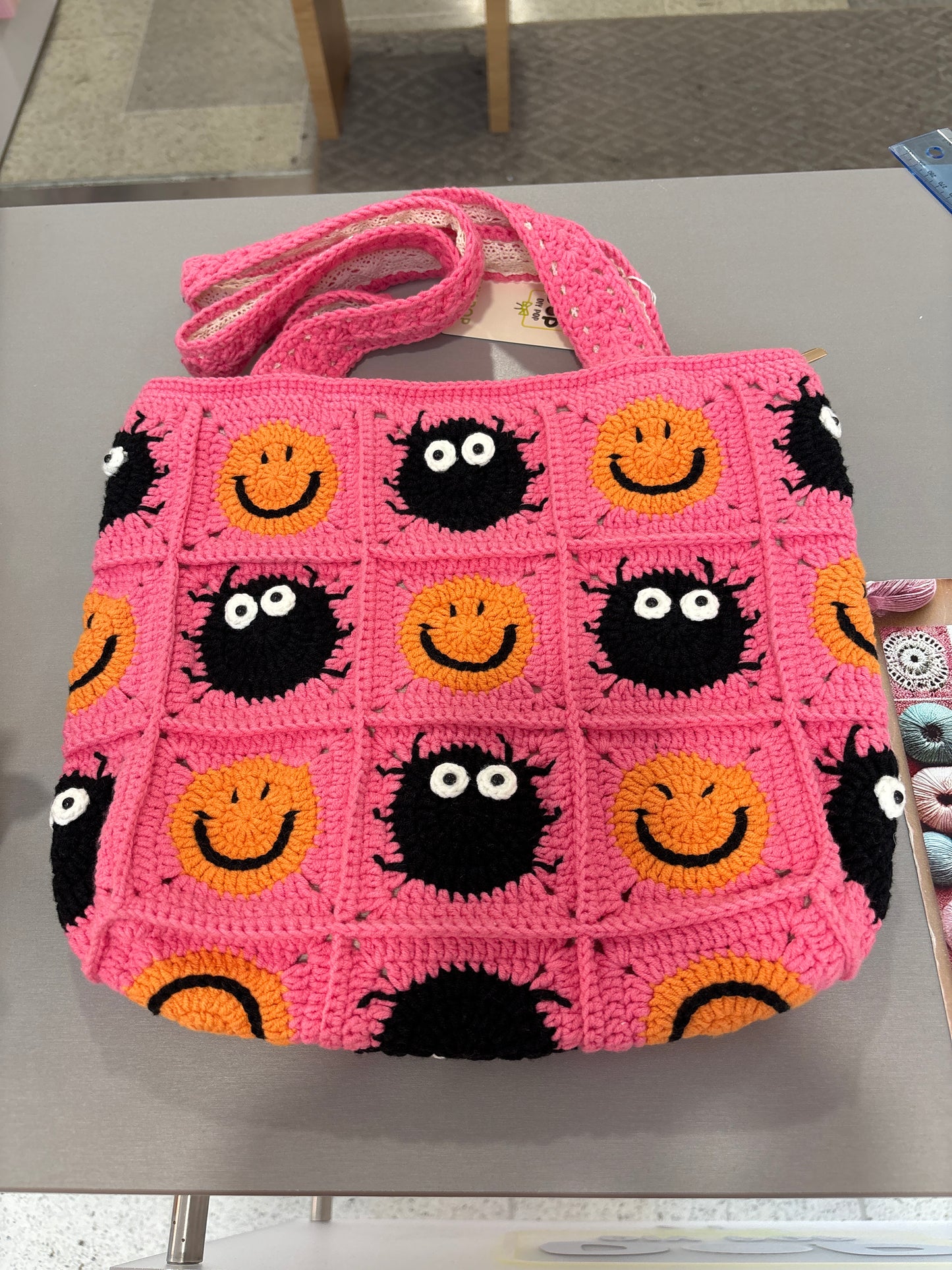handmade crochet bag with a stylish smile face